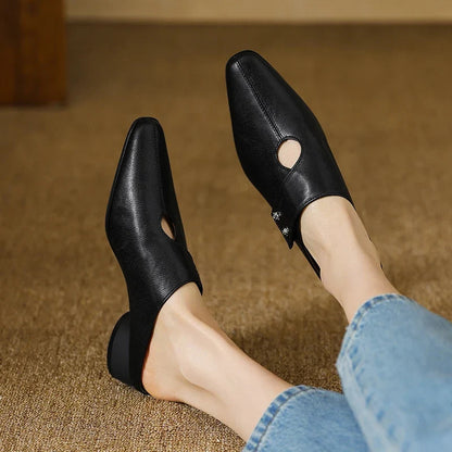Olga mules en cuir noir